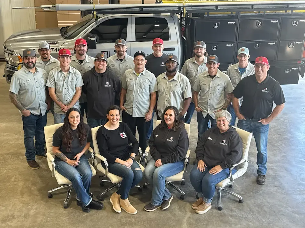 The Group of 16 persons with technicians and an office in a service car with storage boxes. Photo of the Group.