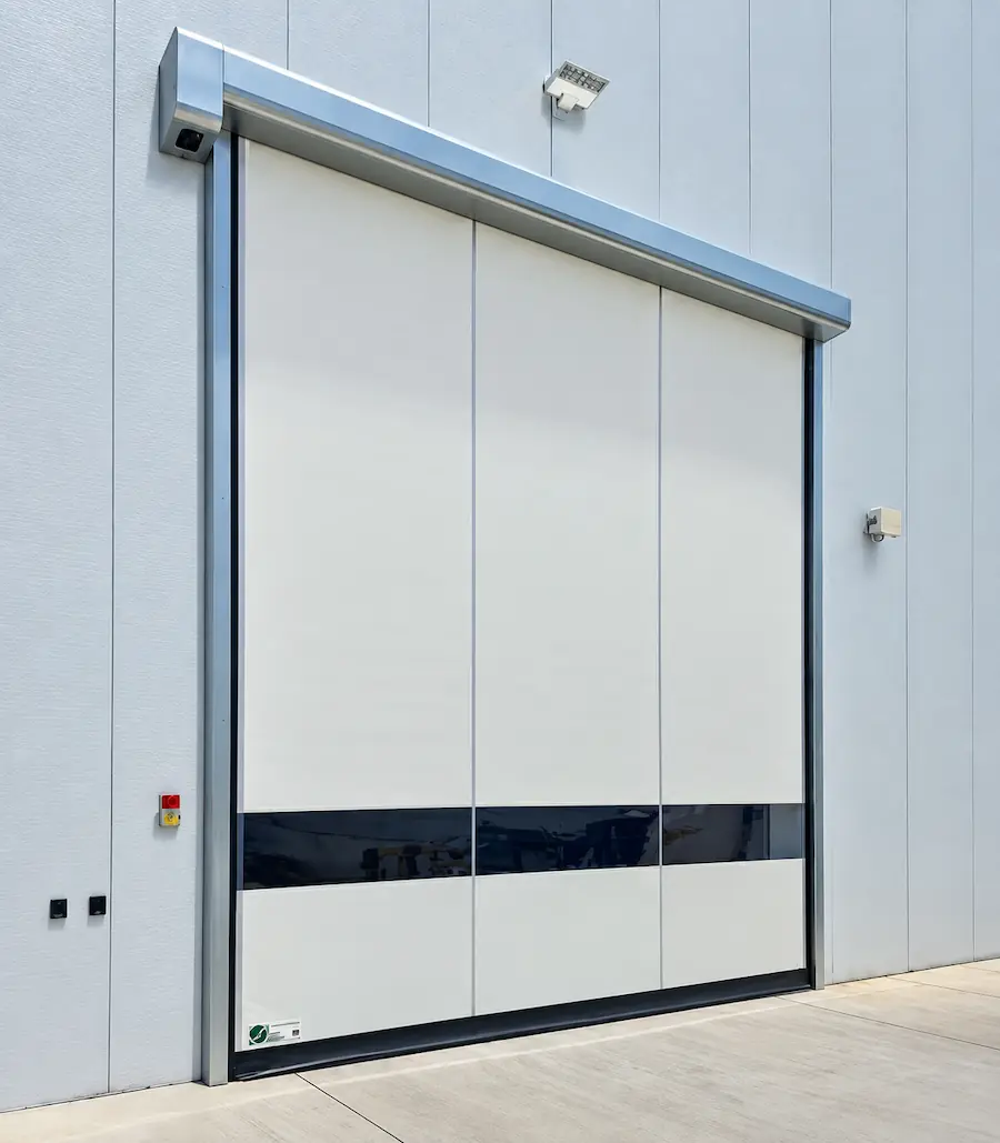 A white high-speed fabric door installed on a commercial building.
