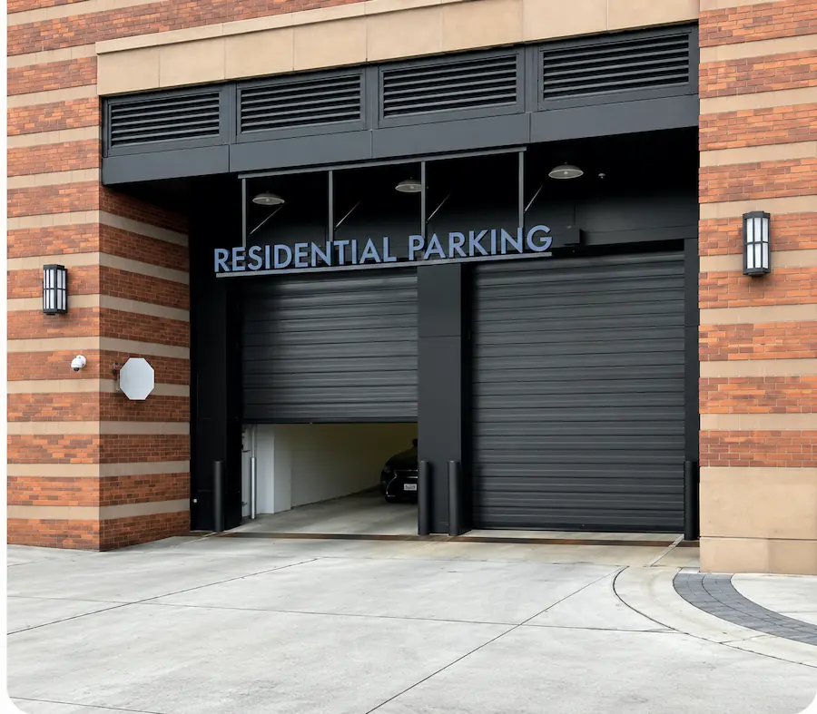 Paired high-speed doors at the entrance to a residential parking garage.